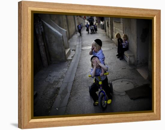 Ultra-Orthodox Jewish Children Cover their Faces as They Play in a Street in Jerusalem-null-Framed Premier Image Canvas