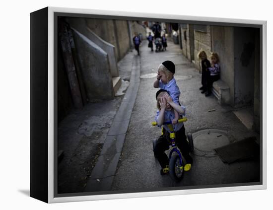 Ultra-Orthodox Jewish Children Cover their Faces as They Play in a Street in Jerusalem-null-Framed Premier Image Canvas