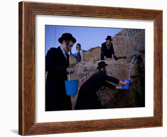 Ultra-Orthodox Jewish Men Stand Next to a Well as They Fill Canisters with Water in Jerusalem-null-Framed Photographic Print