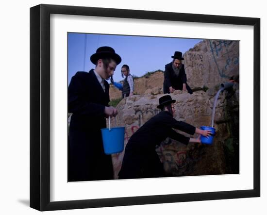 Ultra-Orthodox Jewish Men Stand Next to a Well as They Fill Canisters with Water in Jerusalem-null-Framed Photographic Print