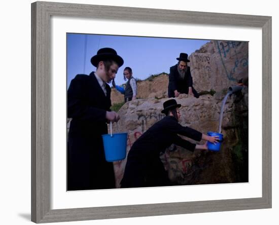 Ultra-Orthodox Jewish Men Stand Next to a Well as They Fill Canisters with Water in Jerusalem-null-Framed Photographic Print