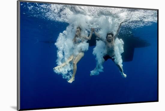 Underwater View of the Young Couple Having Fun and Jumping into the Clear Sea from a Boat-Dudarev Mikhail-Mounted Photographic Print