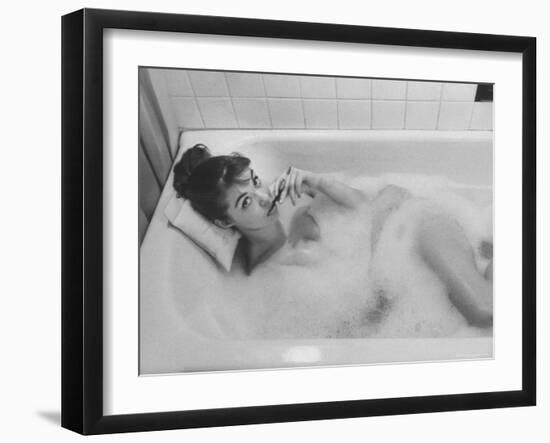 Unexposed Nude Woman in the Bathtub Amid the Bubbles While Smoking a Cigarette-Peter Stackpole-Framed Photographic Print