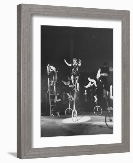 Unicyclists Performering at the Circus-null-Framed Photographic Print