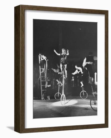 Unicyclists Performering at the Circus-null-Framed Photographic Print