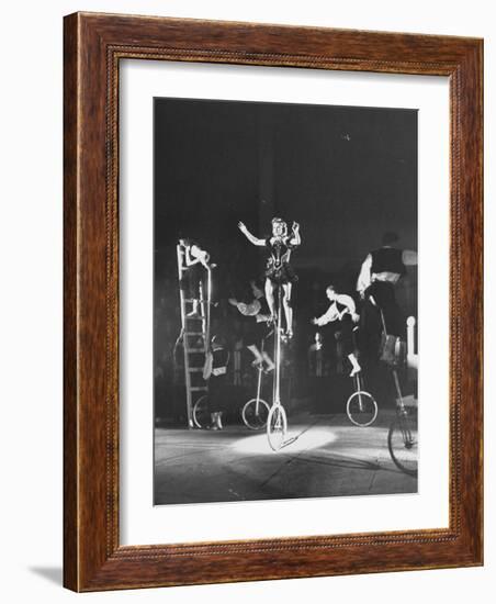 Unicyclists Performering at the Circus-null-Framed Photographic Print