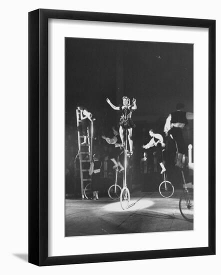 Unicyclists Performering at the Circus-null-Framed Photographic Print