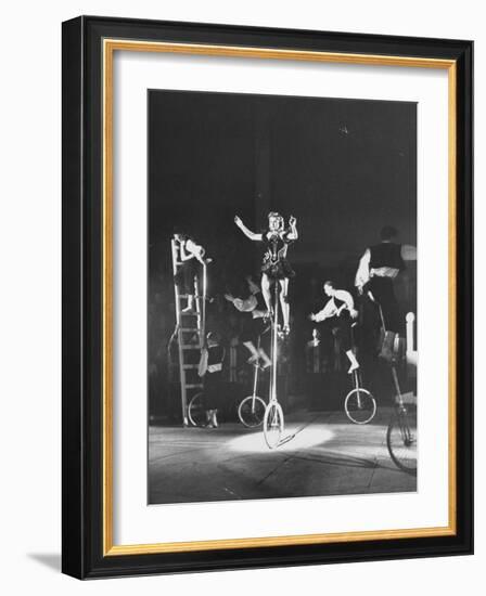 Unicyclists Performering at the Circus-null-Framed Photographic Print