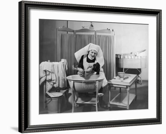 Uniformed Nurse Bathes a Baby in Hospital-null-Framed Photographic Print