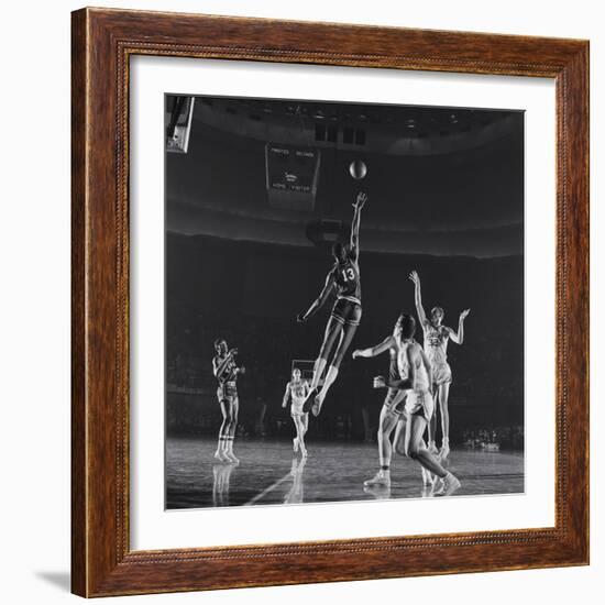 University of Kansas Basketball Player Wilt Chamberlain (C) Playing in a School Game, 1957-George Silk-Framed Photographic Print