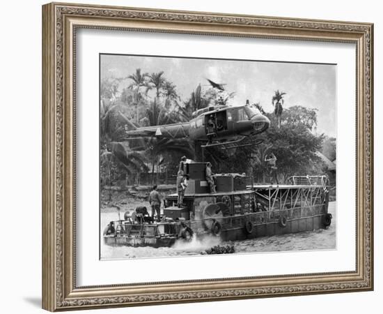 US Army Helicopter Making Mid Stream Landing Atop an Armored Troop Carrier-null-Framed Photographic Print