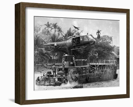 US Army Helicopter Making Mid Stream Landing Atop an Armored Troop Carrier-null-Framed Photographic Print