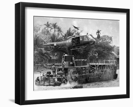 US Army Helicopter Making Mid Stream Landing Atop an Armored Troop Carrier-null-Framed Photographic Print