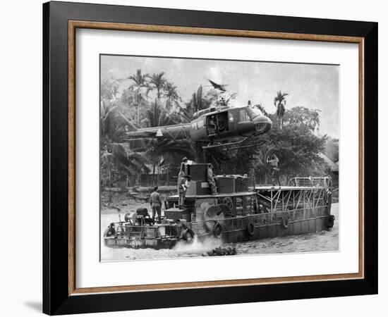 US Army Helicopter Making Mid Stream Landing Atop an Armored Troop Carrier-null-Framed Photographic Print