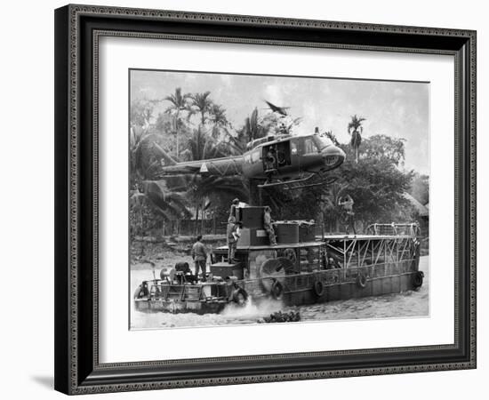 US Army Helicopter Making Mid Stream Landing Atop an Armored Troop Carrier-null-Framed Photographic Print