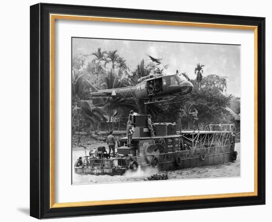 US Army Helicopter Making Mid Stream Landing Atop an Armored Troop Carrier-null-Framed Photographic Print