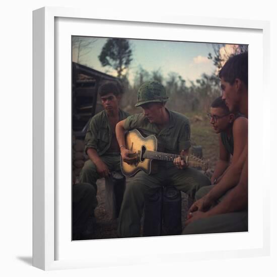 US Army Infantrymen Gather around a Guitar Player and Sing, Vietnam, Jan. 1968-null-Framed Photo