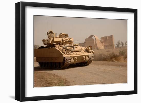 US Bradley Fighting Vehicle Passes by the Palace of Historic Ctesiphon, Feb. 16, 2008-null-Framed Photo