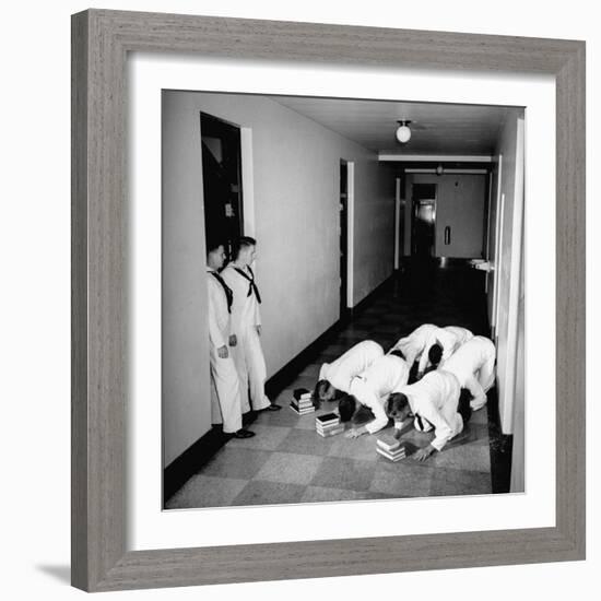 US Coast Guard Academy, Lower Classmen Bowing over Books, Hoping for Luck in Examinations-William C^ Shrout-Framed Photographic Print