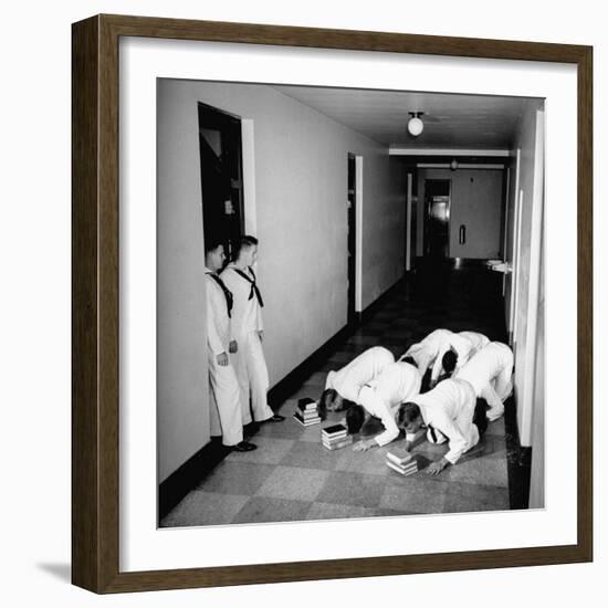 US Coast Guard Academy, Lower Classmen Bowing over Books, Hoping for Luck in Examinations-William C^ Shrout-Framed Photographic Print