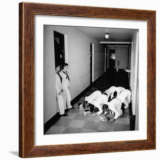 US Coast Guard Academy, Lower Classmen Bowing over Books, Hoping for Luck in Examinations-William C^ Shrout-Framed Photographic Print