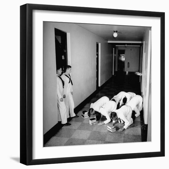 US Coast Guard Academy, Lower Classmen Bowing over Books, Hoping for Luck in Examinations-William C^ Shrout-Framed Photographic Print