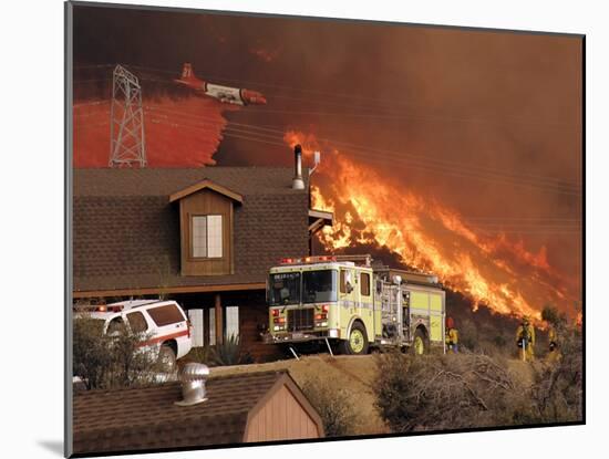 US Forest Service Air Tanker Drops Fire Retardant as the Fire Burns in the Hills Above a Home-null-Mounted Photographic Print