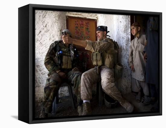 US Marine LCpl Mathew Gorzkiewicz Tries Out an Afghan Boy's Sling During a Patrol in Afghanistan-null-Framed Premier Image Canvas