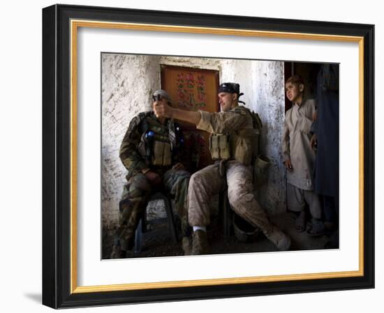 US Marine LCpl Mathew Gorzkiewicz Tries Out an Afghan Boy's Sling During a Patrol in Afghanistan-null-Framed Photographic Print