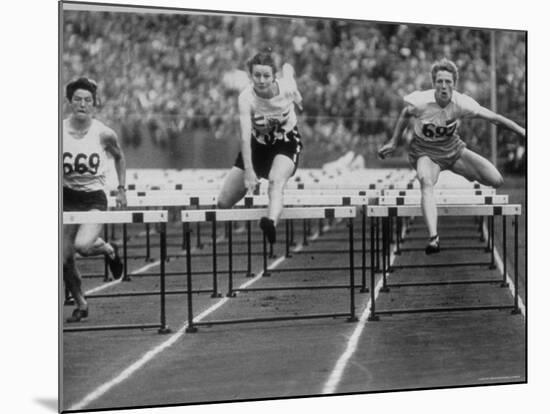 US Runner Fanny Blankers Koen Setting Olympic Record of 11.2 Seconds in 80 Meter Hurdles-Mark Kauffman-Mounted Premium Photographic Print