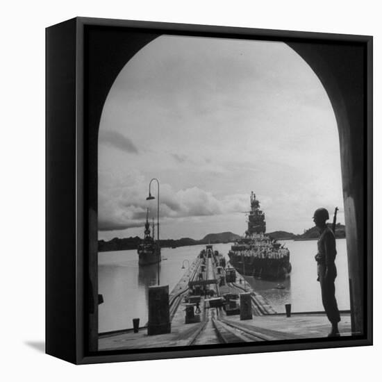 US Soldier Standing Guard over Section of Panama Canal, Battleship with Full Crew on Deck-Thomas D^ Mcavoy-Framed Premier Image Canvas