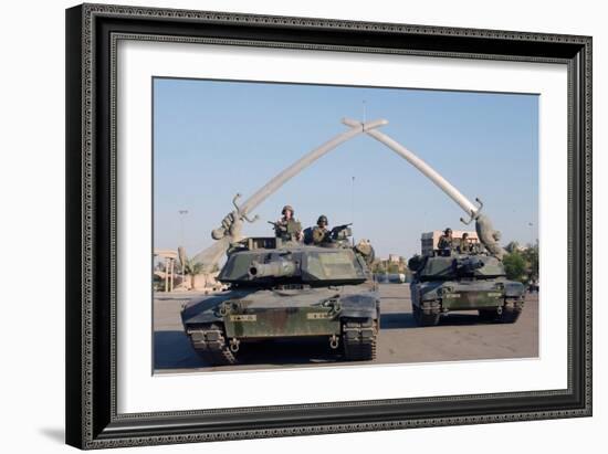 US Tanks Drive under the 'Hands of Victory' in Baghdad, Iraq, Ca. 2003-null-Framed Photo