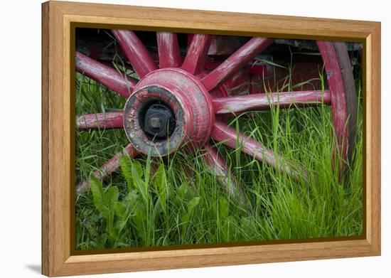USA, Alaska, Chena Hot Springs. Vintage wagon wheel and grass.-Jaynes Gallery-Framed Premier Image Canvas