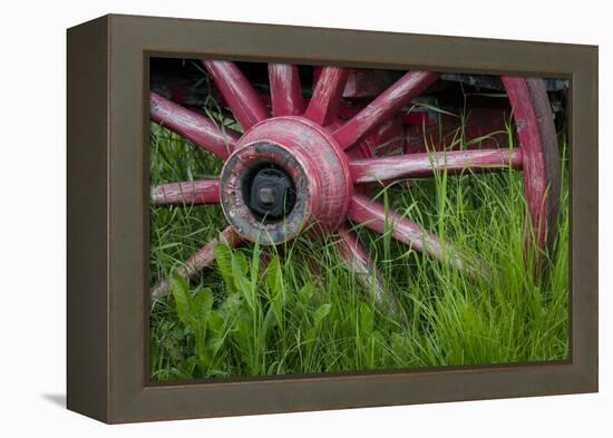 USA, Alaska, Chena Hot Springs. Vintage wagon wheel and grass.-Jaynes Gallery-Framed Premier Image Canvas