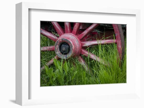 USA, Alaska, Chena Hot Springs. Vintage wagon wheel and grass.-Jaynes Gallery-Framed Photographic Print