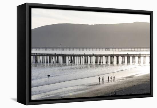 USA, California, Avila Beach. Silhouetted Beach Walkers Approach Pier End of Day-Trish Drury-Framed Premier Image Canvas