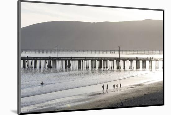 USA, California, Avila Beach. Silhouetted Beach Walkers Approach Pier End of Day-Trish Drury-Mounted Photographic Print