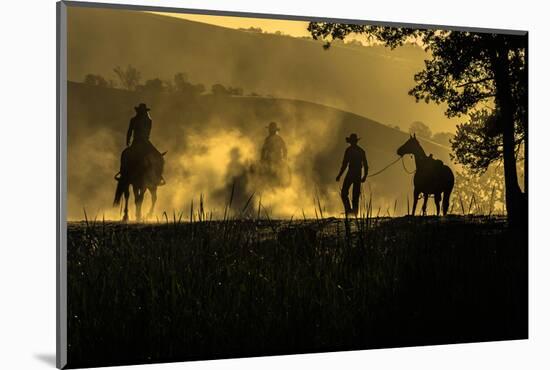 USA, California, Parkfield, V6 Ranch silhouette of riders, on horseback. Early dusty morning.-Ellen Clark-Mounted Photographic Print