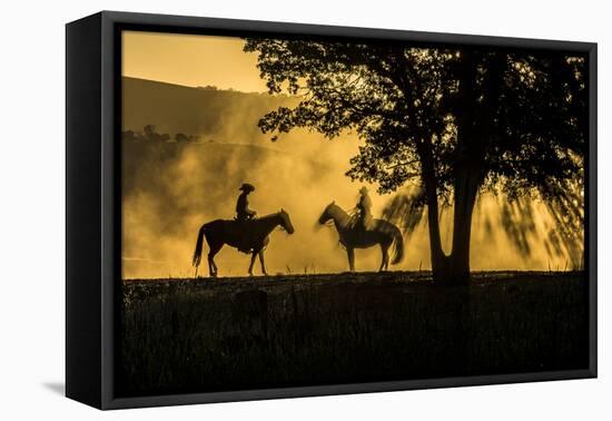 USA, California, Parkfield, V6 Ranch silhouette of two riders on horseback. Early dusty morning.-Ellen Clark-Framed Premier Image Canvas