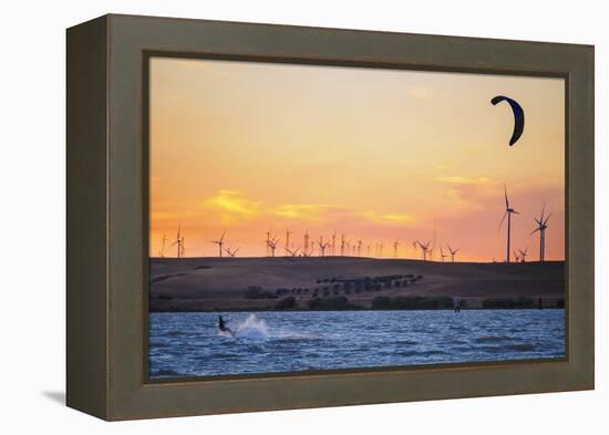 Usa, California, Rio Vista. Kiteboarder at sunset with wind farm turbines.-Merrill Images-Framed Premier Image Canvas