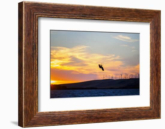 USA, California, Rio Vista, Sacramento River Delta. Kiteboarder catching air at sunset.-Merrill Images-Framed Photographic Print