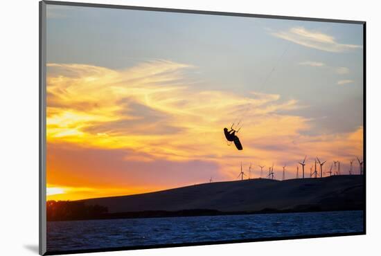 USA, California, Rio Vista, Sacramento River Delta. Kiteboarder catching air at sunset.-Merrill Images-Mounted Photographic Print