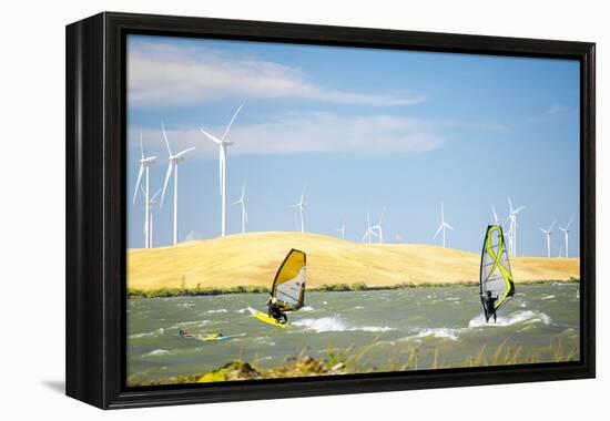 Usa, California, Rio Vista, Sacramento River Delta. Sailboarders with wind turbines.-Merrill Images-Framed Premier Image Canvas