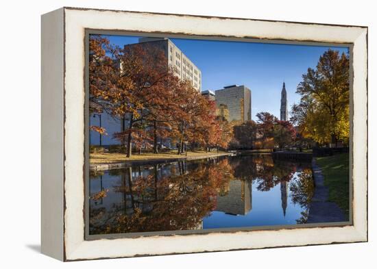 USA, Connecticut, Hartford, Bushnell Park, reflection of office buildings and Travelers Tower-Walter Bibikow-Framed Premier Image Canvas