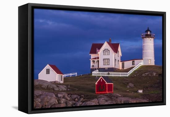 USA, Maine, York Beach, Nubble Light Lighthouse with Christmas decorations at dusk-Walter Bibikow-Framed Premier Image Canvas