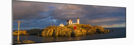 USA, Maine, York Beach, Nubble Light Lighthouse with Christmas decorations, sunset-Walter Bibikw-Mounted Photographic Print