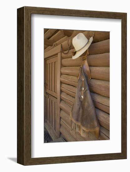 USA, Montana, Livingston, cowboy hat and chaps hanging on barn wall.-Merrill Images-Framed Photographic Print