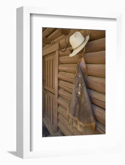 USA, Montana, Livingston, cowboy hat and chaps hanging on barn wall.-Merrill Images-Framed Photographic Print