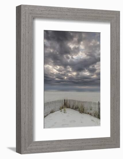 USA, New Jersey, Cape May National Seashore. Beach fence and stormy sunrise.-Jaynes Gallery-Framed Photographic Print