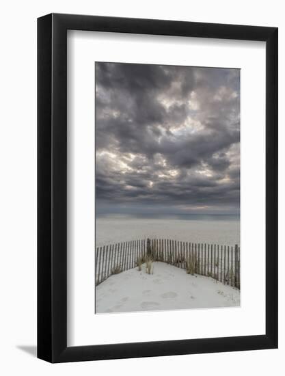 USA, New Jersey, Cape May National Seashore. Beach fence and stormy sunrise.-Jaynes Gallery-Framed Photographic Print